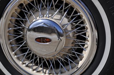 True wire wheels with brown and gold logo in center cap
Originally equipped with Uniroyal Gold Stripe radial tires
