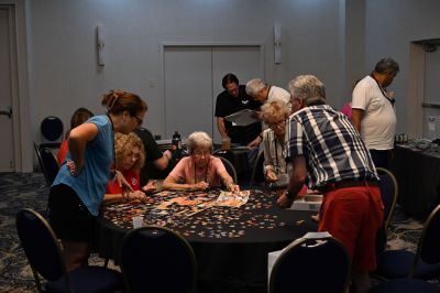 Members enjoying the A/C in the ROA Hospitality Room ...
Several members using the time to work on a crossword puzzle
