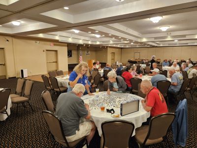 Members enjoying the A/C in the ROA Hospitality Room …
… Using the time to work on a crossword puzzle
